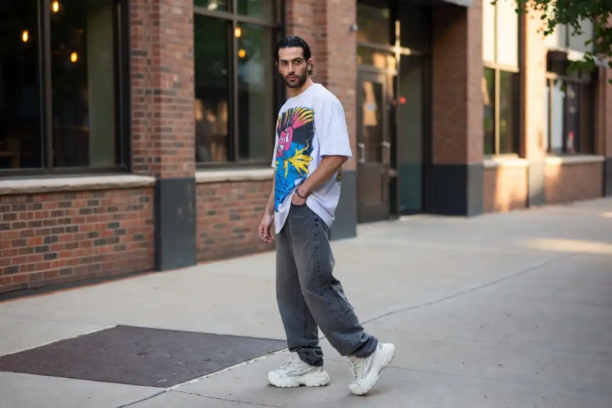 Man wearing 90s mens fashion streetwear with baggy jeans and chunky sneakers