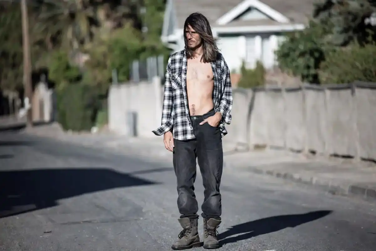 90s mens fashion grunge look with flannel shirt dark jeans and boots