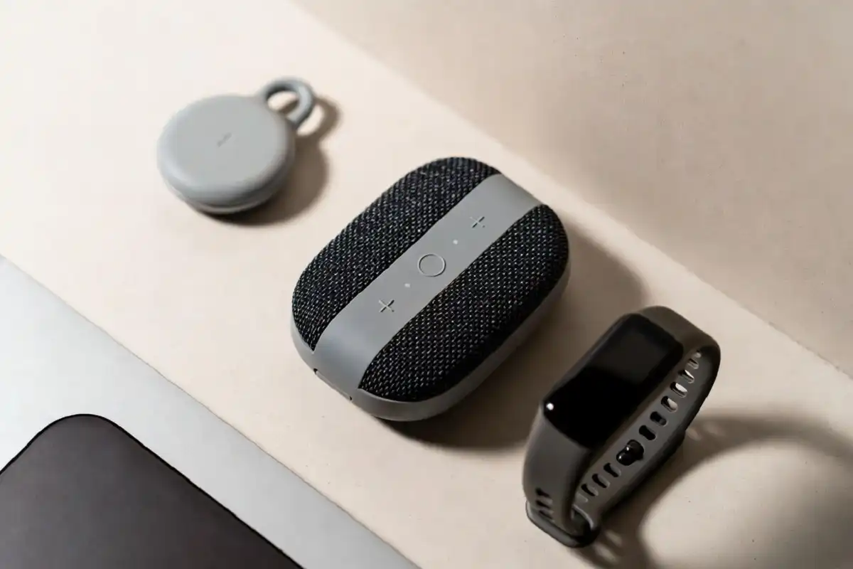 Small affordable smart gadgets like trackers and a fitness band in a flat lay