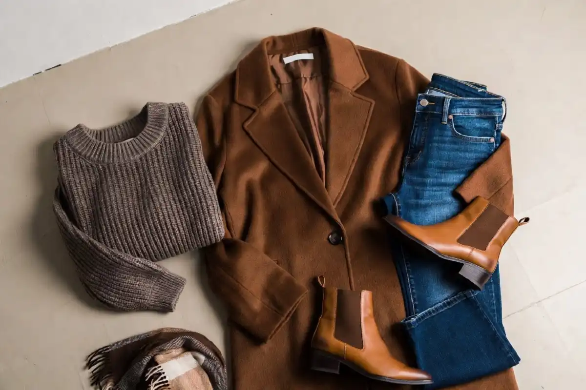 Flat-lay of fall wardrobe staples in warm autumn colors