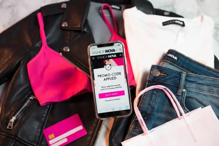 Fashion Nova discount codes displayed on a smartphone screen next to stylish clothing and shopping bags