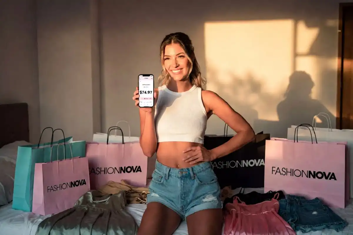 Happy shopper with Fashion Nova haul bags after using discount codes to save on stylish outfits