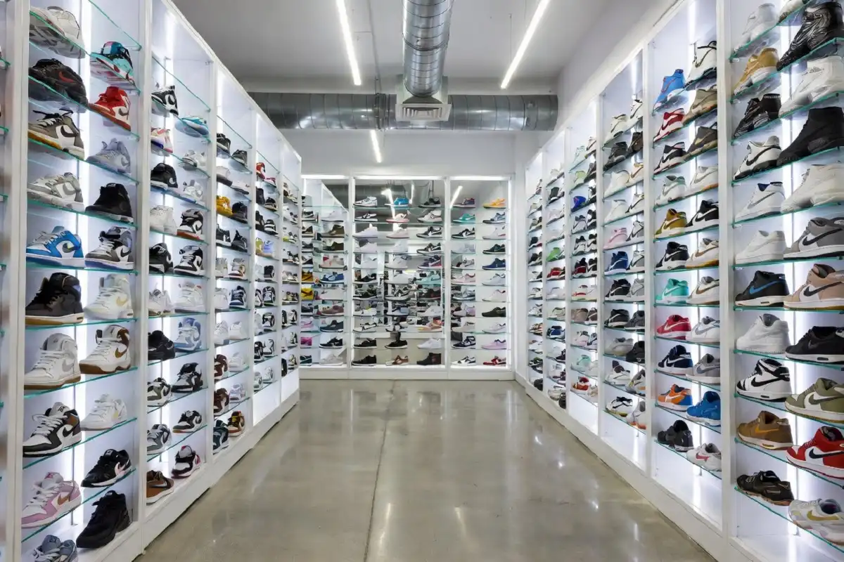 Person browsing fashion sneakers in a modern retail store setting