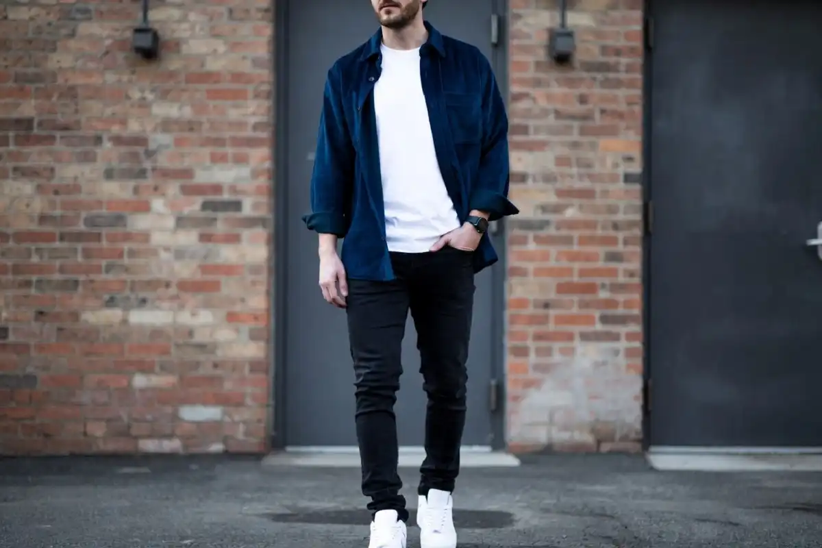 Man demonstrating frugal male fashion layering technique in casual streetwear outfit