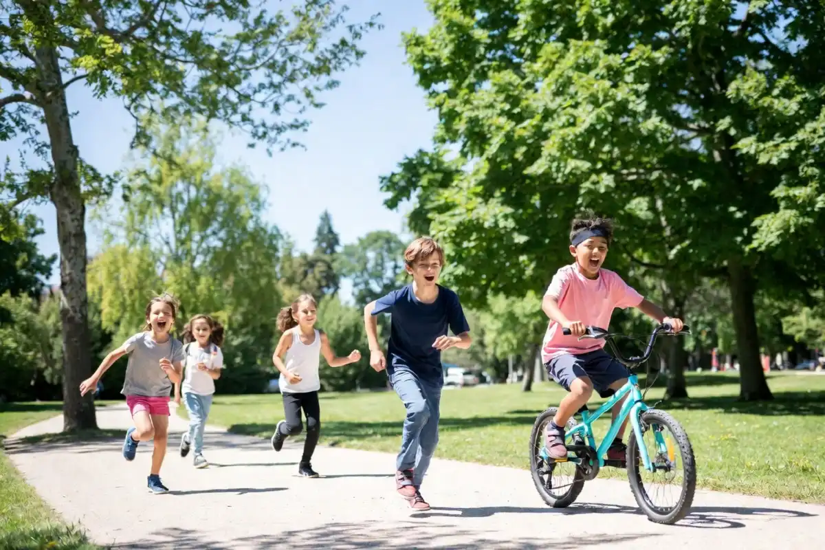 Children playing and exercising outdoors in a sunny park