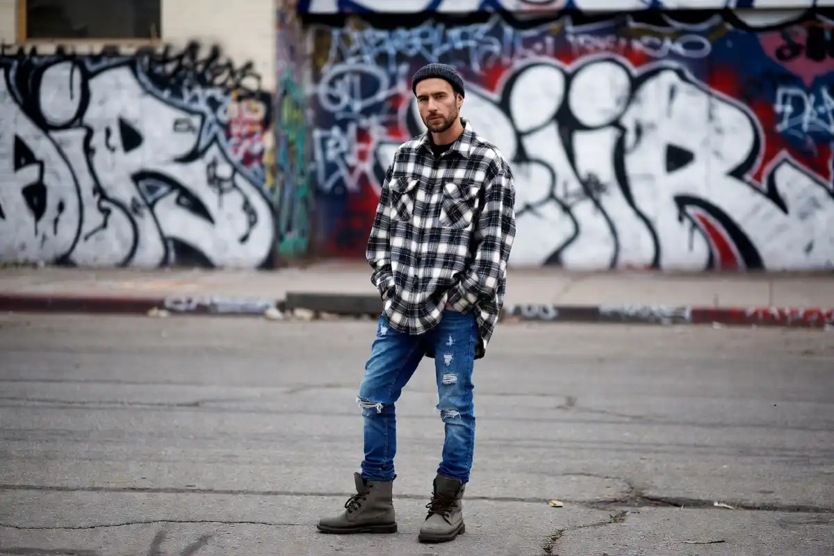 Men's 90s grunge fashion with flannel and ripped jeans