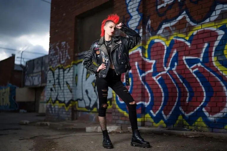 Young woman wearing punk fashion leather jacket with studs and patches on urban street