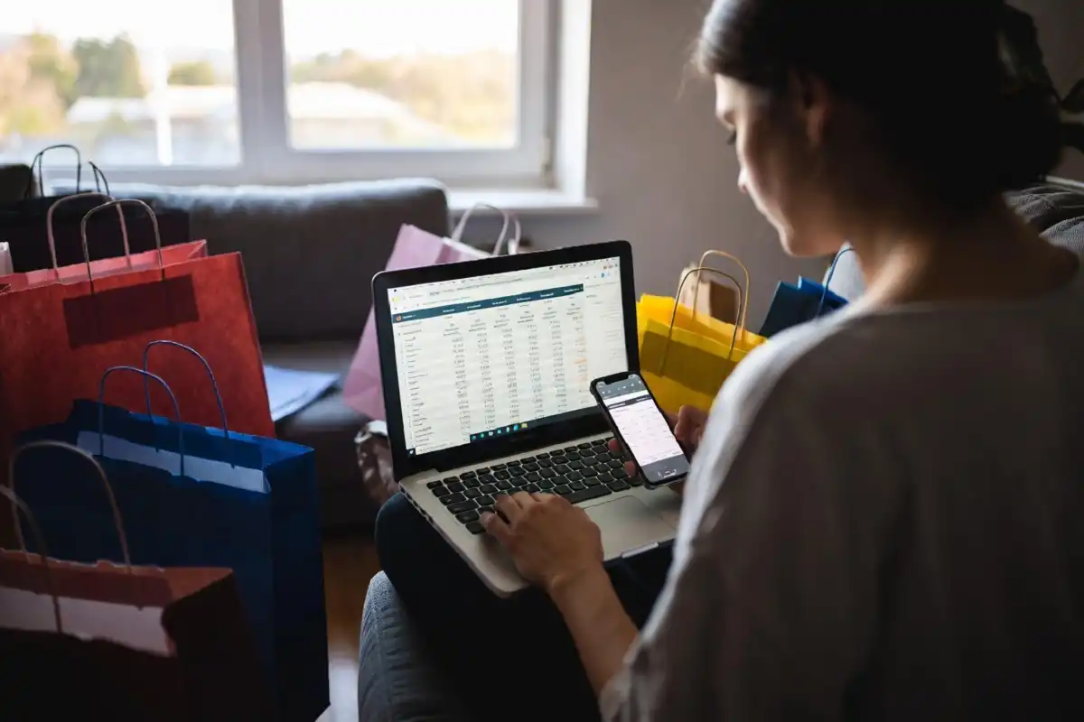 Shopper comparing online and in-store festive season deals