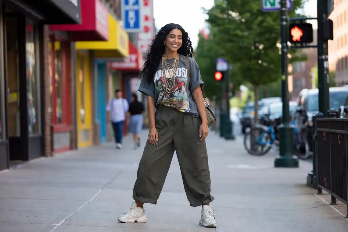 Confident woman wearing a stylish Viva Fashion urban streetwear outfit on a city street