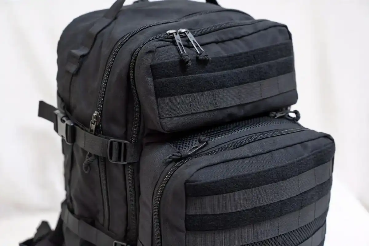 Close-up of MOLLE webbing and compartments on a tactical backpack